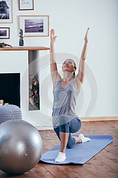 Young cheerful attractive woman practicing yoga