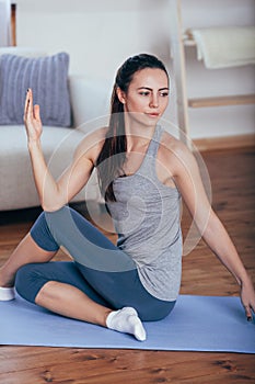Young cheerful attractive woman practicing yoga