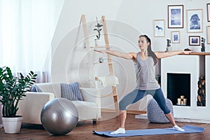 Young cheerful attractive woman practicing yoga