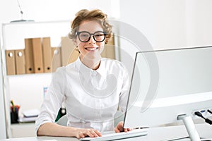 Young cheerful business woman with computer