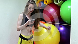 Young cheerful caucasian women listening to music in a fitness club.