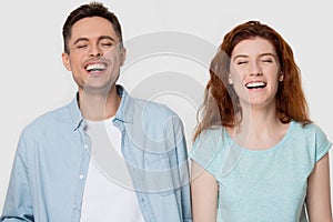 Young cheerful couple laughing at humorous silly funny joke together