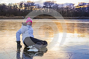 Young cheerful girl skating on the lake.