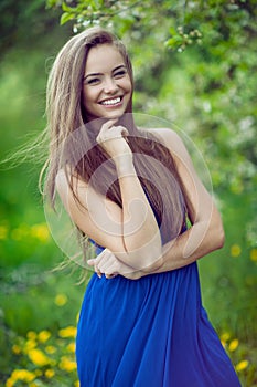 Young cheerful and happy girl posing in spring park