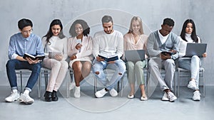 Young cheerful international group of people waiting for job interview