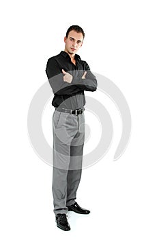 Young cheerful man in black shirt, full length portrait of attractive guy looking at camera over white