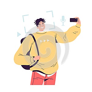 Young cheerful man with a phone in his hand takes pictures of himself for a blog and social networks.
