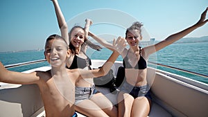 Young cheerful people having fun in boat