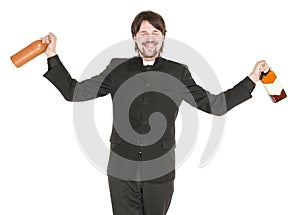 Young cheerful priest with bottle of alcohol isolated