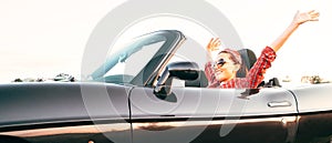 Young cheerful smiling female driving convertible car at sunny day time headers web site