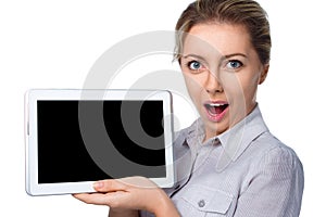 Young cheerful surprised woman is showing blank tablet