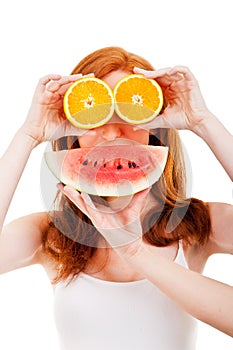 Young cheerful woman with oranges and watermellon