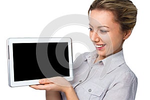 Young cheerful woman is showing blank tablet