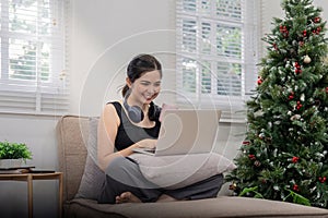 Young cheery happy positive cute beautiful business woman sit indoor in home using laptop computer