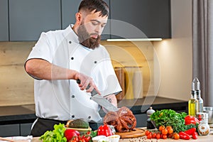 Young chef is cutting octopus in a modern kitchen. The man prepares food at home. Cooking healthy and tasty food.