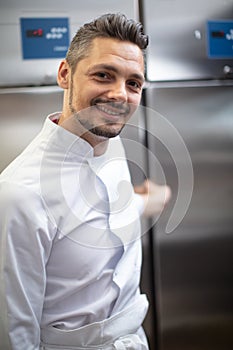 young chef opening restaurant kitchen fridge