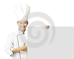 Young chef with thumb up and showing empty board