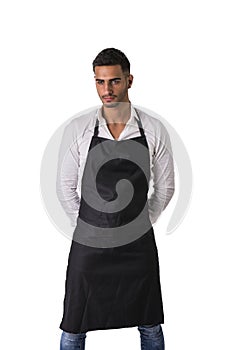 Young chef or waiter wearing black apron