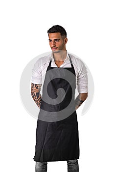 Young chef or waiter wearing black apron