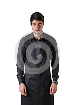 Young chef or waiter wearing black apron isolated