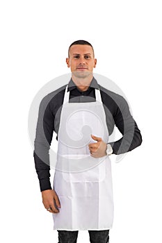 Young chef or waiter wearing black apron isolated