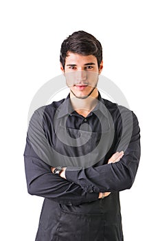 Young chef or waiter wearing black apron isolated