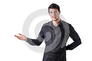 Young chef or waiter wearing black apron isolated