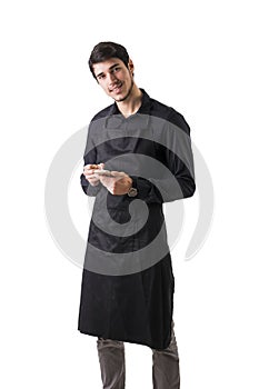 Young chef or waiter wearing black apron isolated