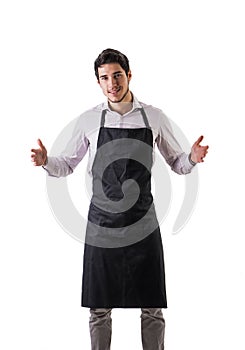 Young chef or waiter wearing black apron isolated