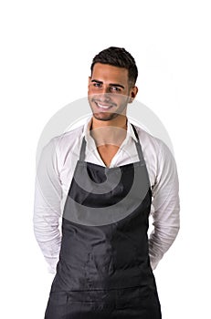 Young chef or waiter wearing black apron isolated