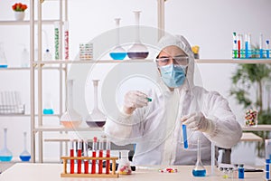 Young male chemist in drugs syntesis concept photo