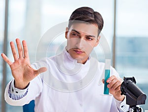 Young chemist pressing virtual buttons in lab