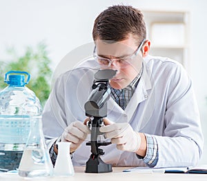 Young chemist student experimenting in lab