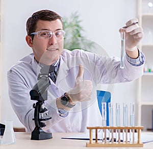 Young chemist student experimenting in lab