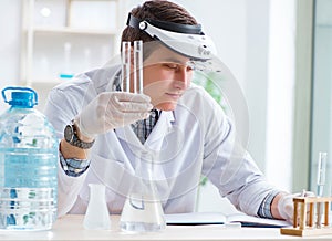 Young chemist student experimenting in lab