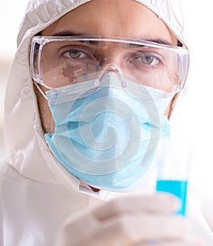 Young chemist student working in lab on chemicals