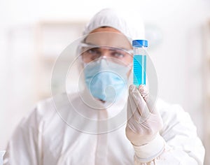 Young chemist student working in lab on chemicals