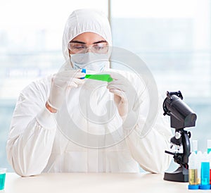 Young chemist student working in lab on chemicals