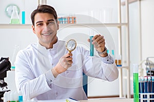 The young chemist student working in lab on chemicals