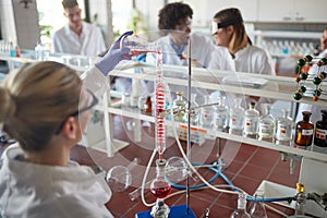 Young chemistry students having a good time while working on an experiment in a laboratory. Science, chemistry, lab, people