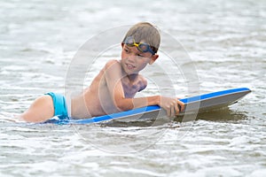 Young child with a bodyboard on the beach