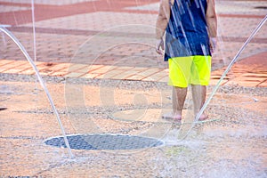 Young child in city splash pad