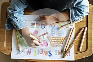 Young child colouring home sweet home