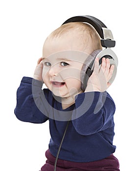 Young child with ear-phones listening to music