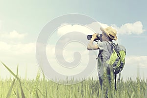 Young child explorer looking at the infinite with his binoculars