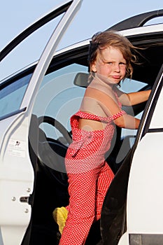 Young child girl getting ready for car trip