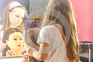 Young child girl making a hair style as a hairdresser