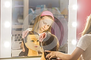 Young child girl making a hair style as a hairdresser