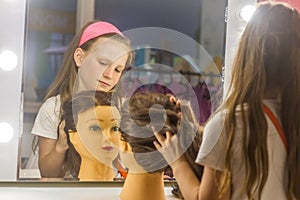 Young child girl making a hair style as a hairdresser