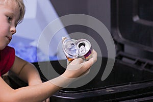 Young Child Holding Crushed Aluminum Cans Representing Concept to Recycle for Their Future